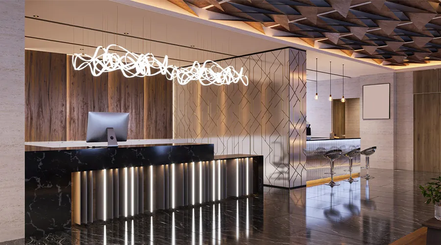 Bancone reception in marmo nero con illuminazione integrata in una lobby contemporanea
